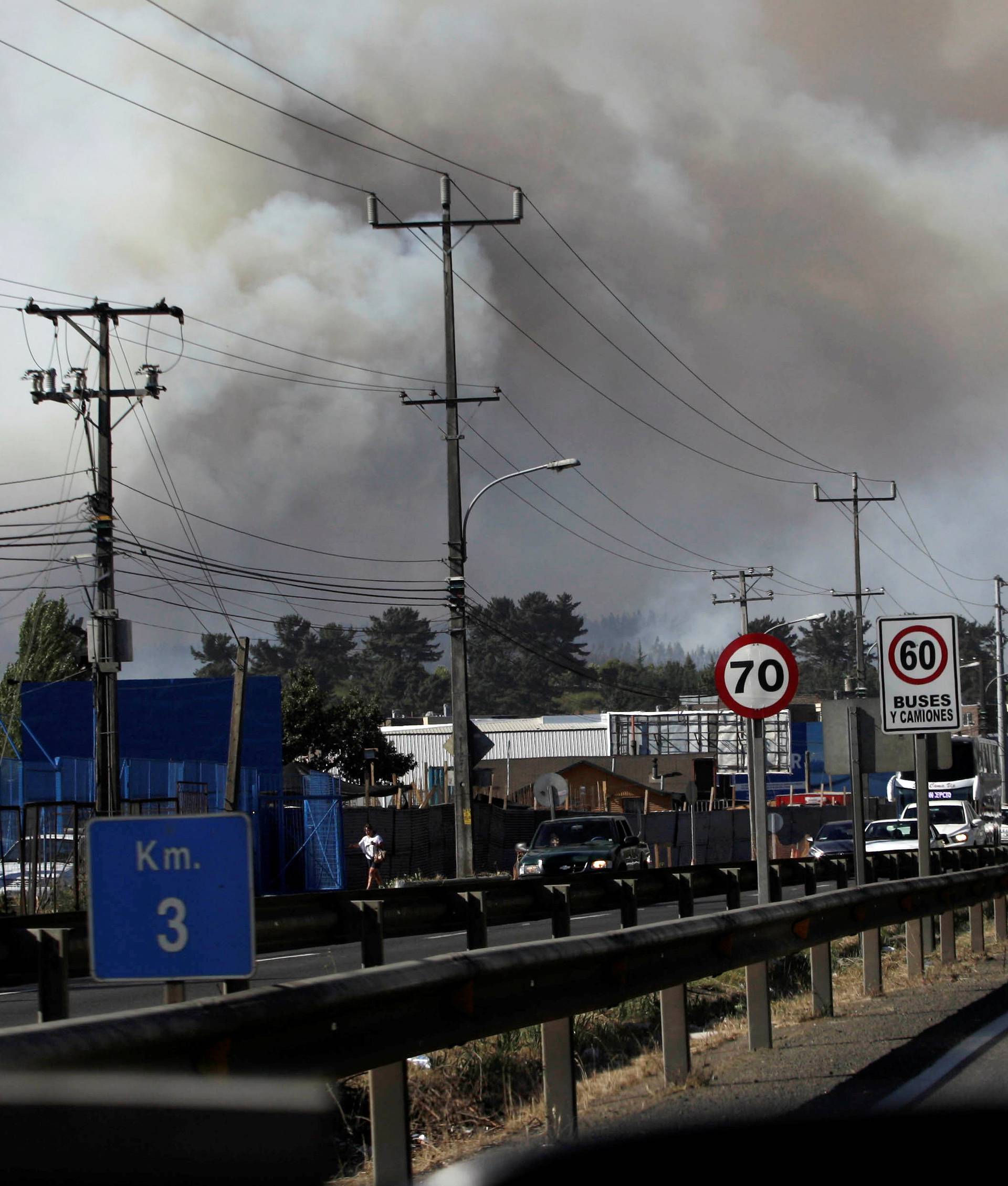 Smoke from the forest fire is seen from the town of Penco in the Concepcion region, south of Chile?