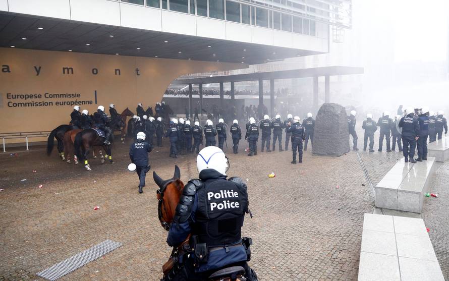 Police officers and mounted police face off with far-right supporters during a protest against Marrakesh Migration Pact, outside European Commission headquarters, in Brussels