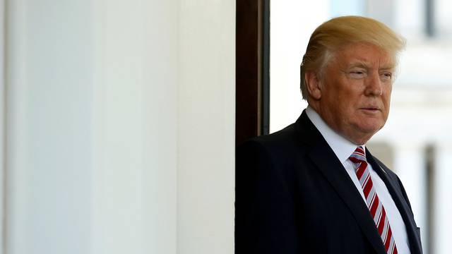 U.S President Donald Trump watches as Turkey's President Recep Tayyip Erdogan departs at the entrance to the West Wing of the White House in Washington