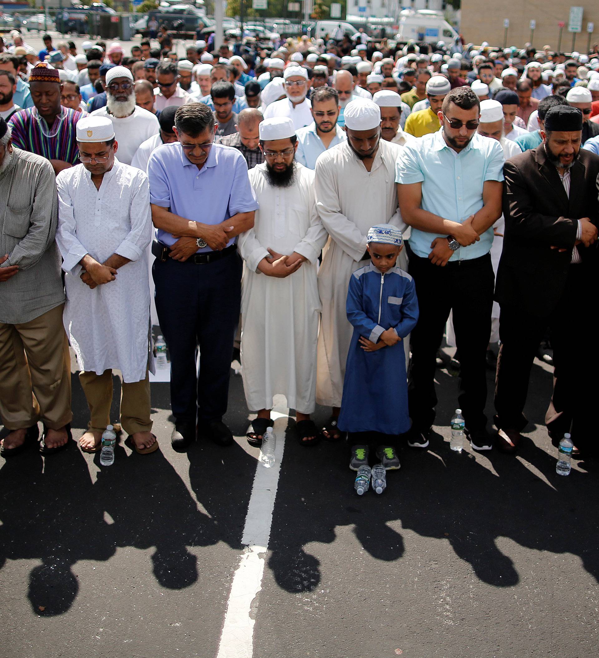 Community members pray during the funeral service of Akonjee, and Uddin in the Queens borough of New York City