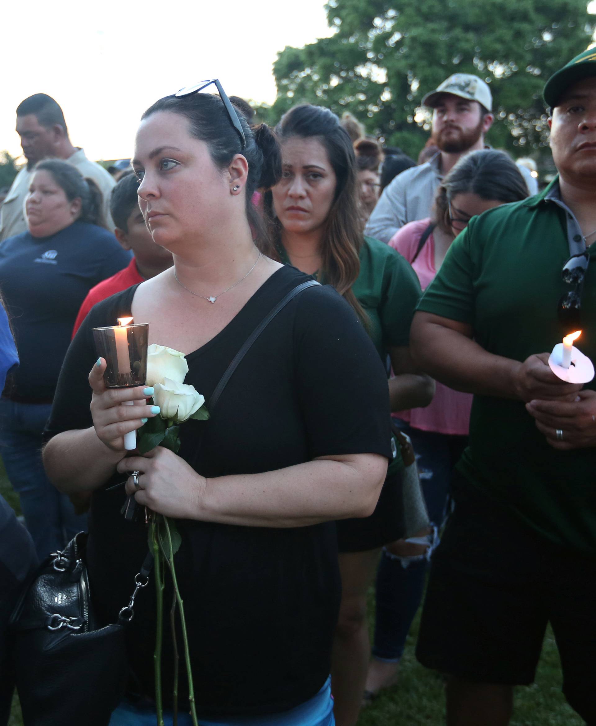 People gather with candles during a vigil held after a shooting left several people dead at Santa Fe High School in Santa Fe, Texas