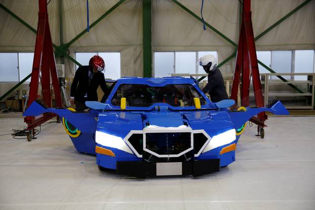 New transforming robot called "J-deite RIDE" that transforms itself into a passenger vehicle, developed by Brave Robotics Inc, Asratec Corp and Sansei Technologies Inc, demonstrates during its unveiling at a factory near Tokyo
