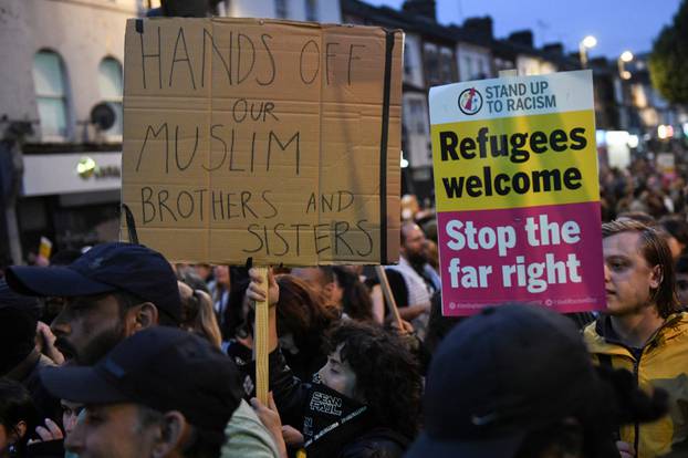 People gather against an an anti-immigration protest, in London