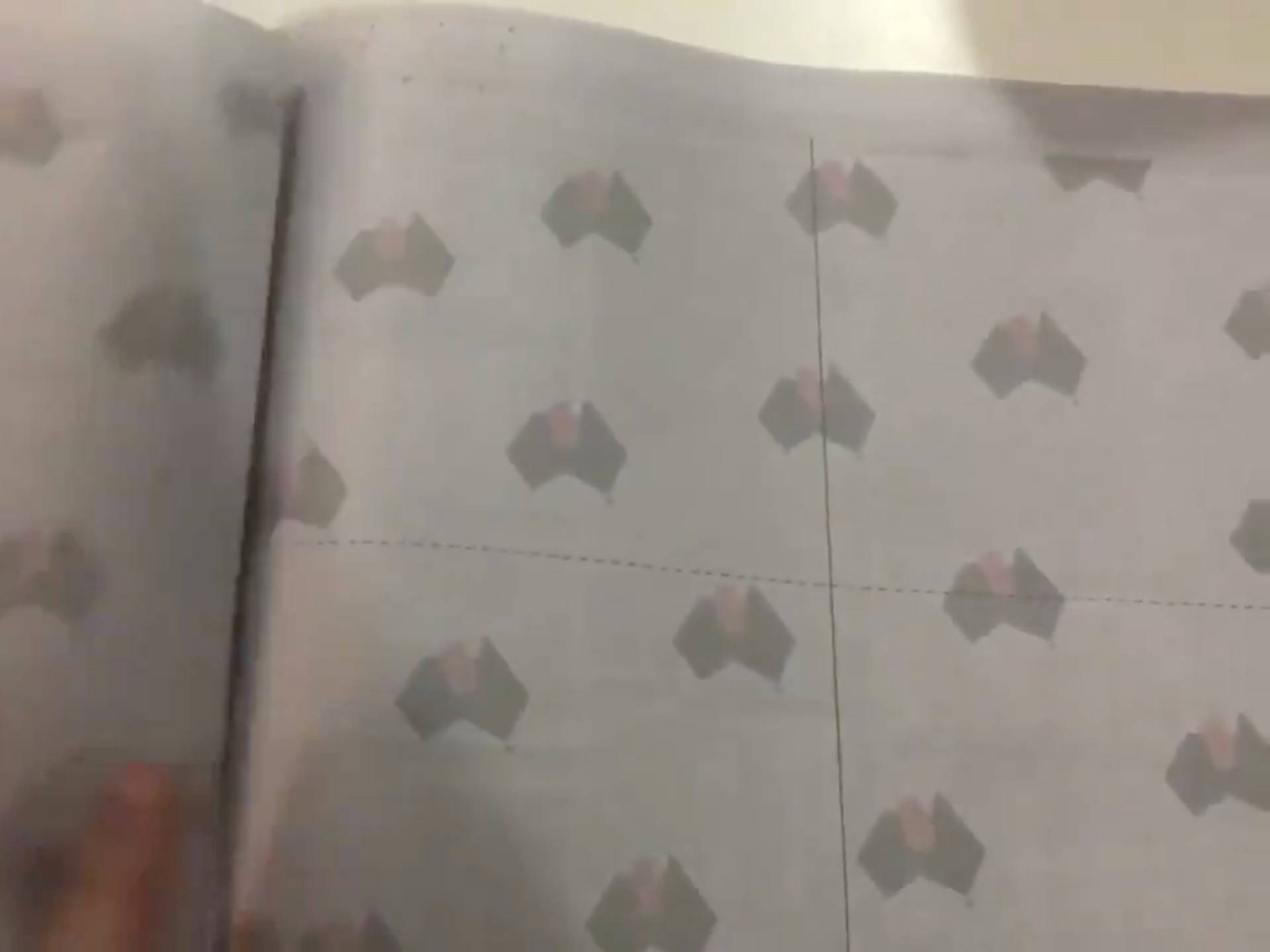 Pages of the Australian newspaper NT News are flipped to show pages with liftout and cut lines in their "toilet paper" edition in Darwin, Australia in this still image from video