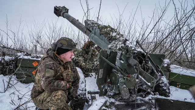 A Ukrainian serviceman of 2 battalion 92nd brigade prepares a 120-mm towed artillery pieces-mortar, at a position near Bakhmut