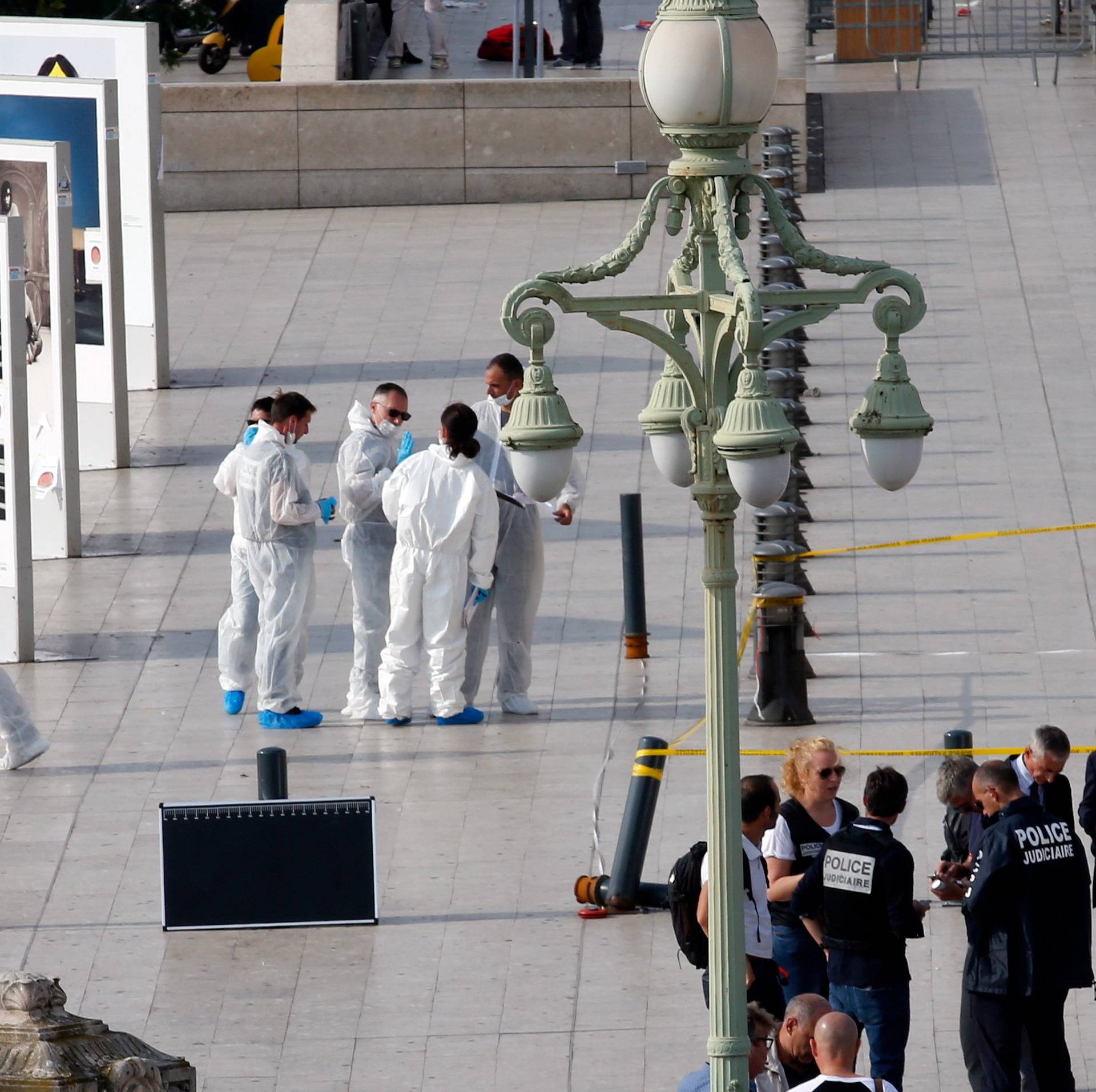 Police investigators work outside the Saint-Charles train station after French soldiers shot and killed a man who stabbed two women to death at the main train station in Marseille