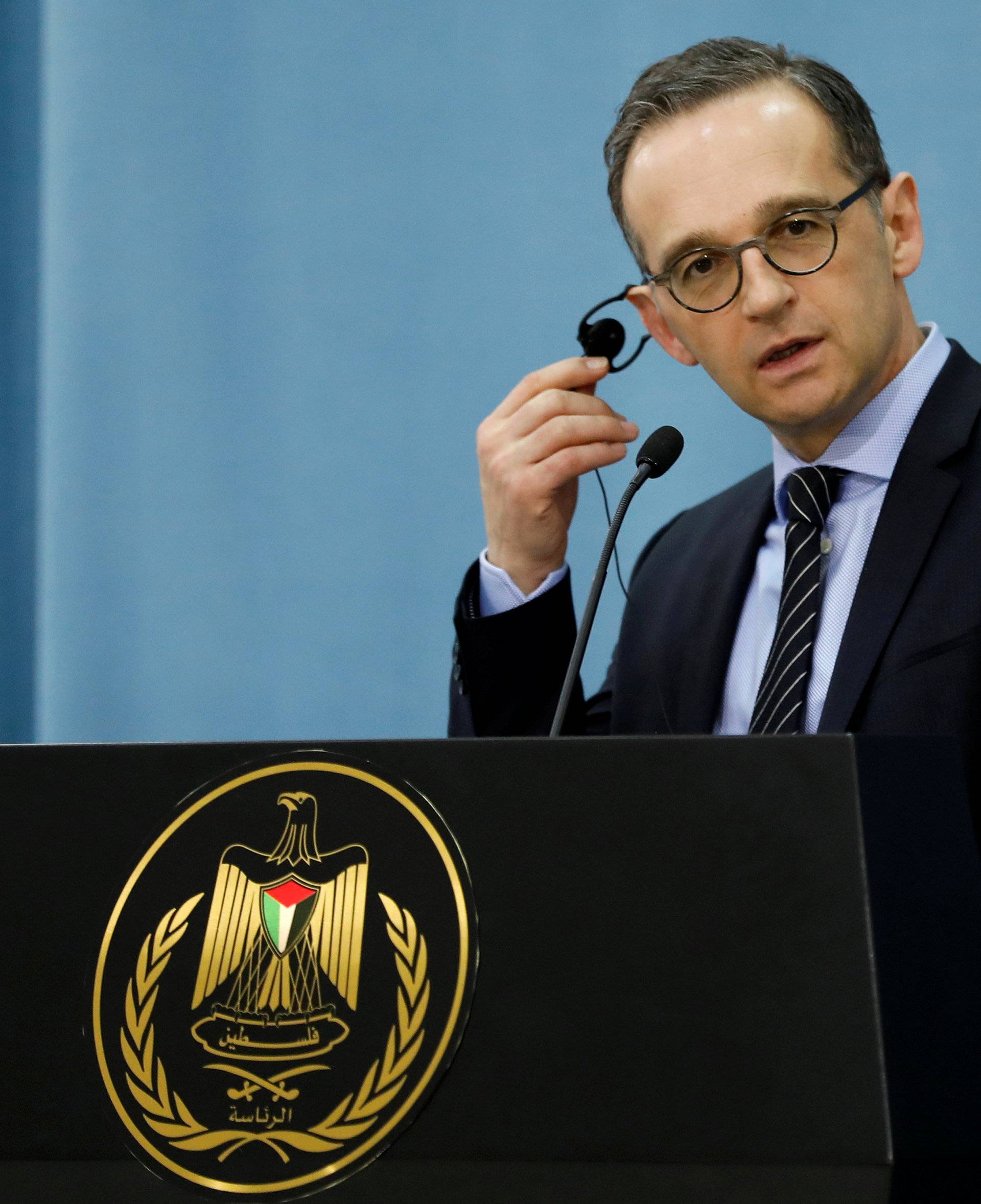 German FM Heiko Maas listens during a news conference with Palestinian FM Al Maliki in Ramallah, in the occupied West Bank