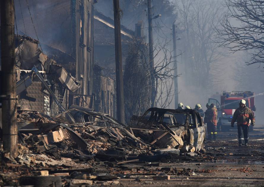 Firefighters work on the site where a cargo train derailed and exploded in the village of Hitrino