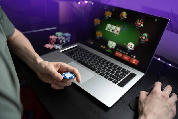 Young,Man,Play,Online,Poker,In,Laptop.,Unrecognizable,Person,In
