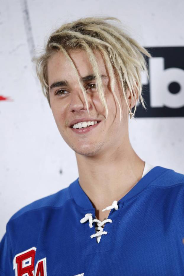 FILE PHOTO: Recording artist Justin Bieber poses backstage after winning the Dance Song of The Year Award for "Where Are U Now" and Male Artist of the Year Award at the 2016 iHeartRadio Music Awards in Inglewood