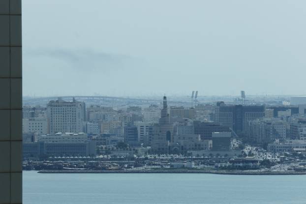 Smoke is left in the sky after blasts were heard in Doha