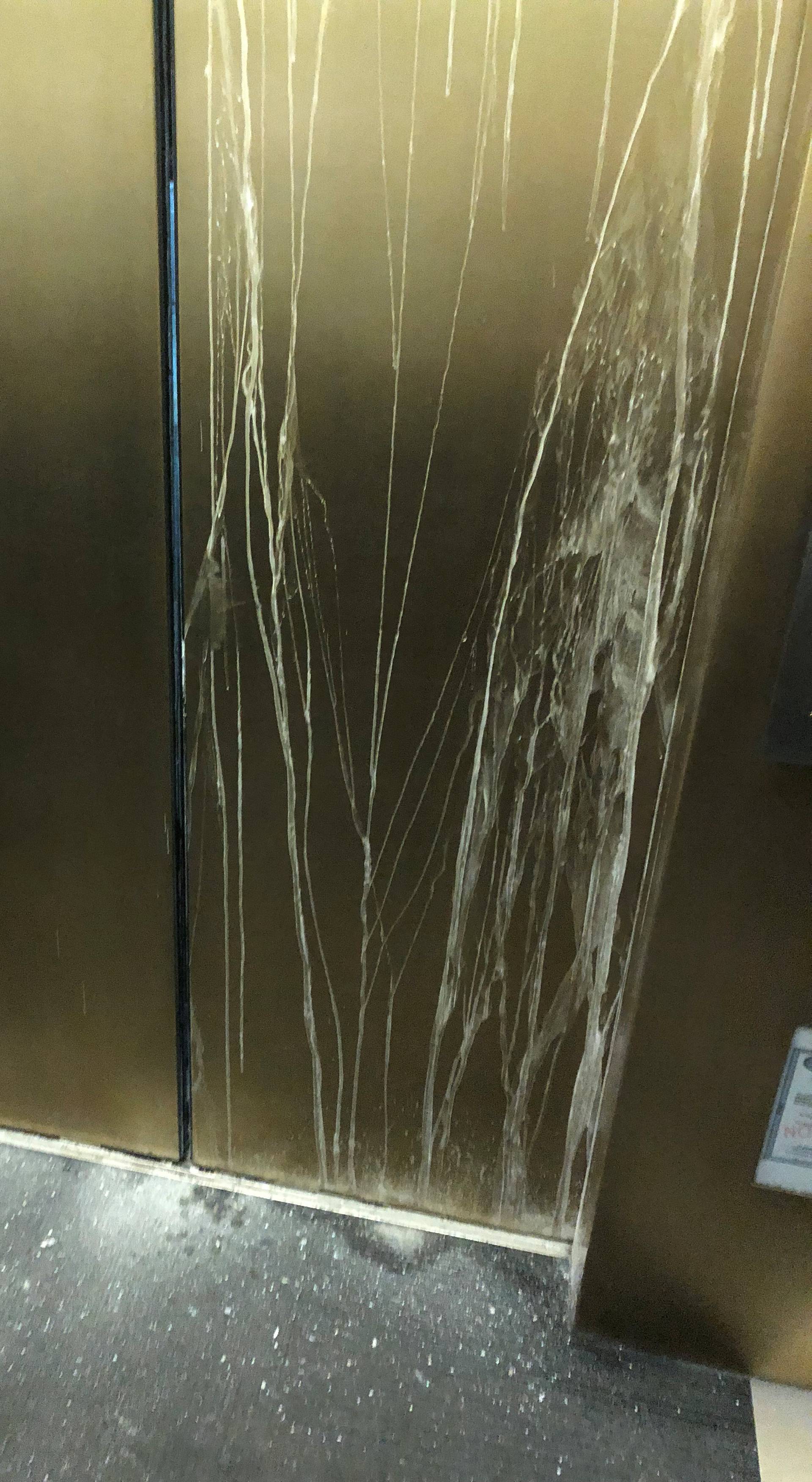 Cracked door of an elevator with six people trapped inside is pictured as the rescue crew try to open it, in the 875 North Michigan Avenue building in Chicago