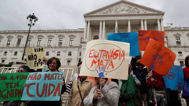 Demonstrators attend a protest against euthanasia in front off the parliament in Lisbon