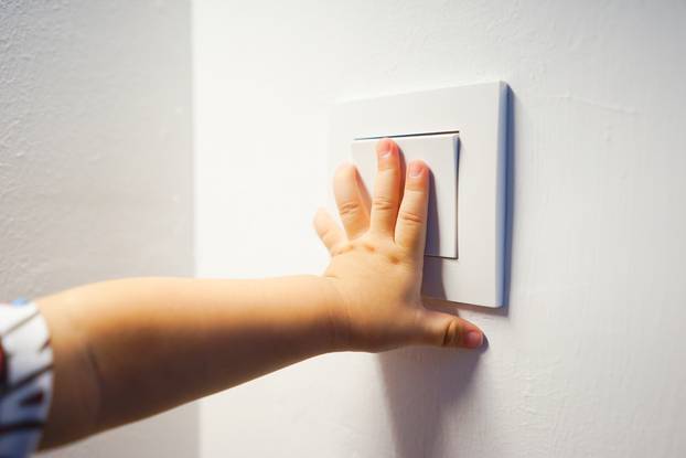Child,Hand,Turning,On,The,Light,With,A,Wall,Switch