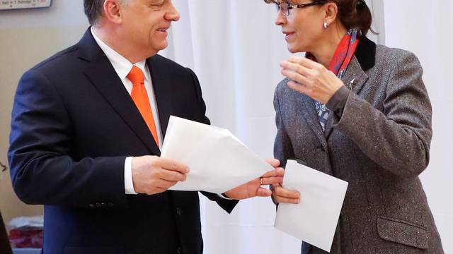 Current Hungarian Prime Minister Viktor Orban and his wife Aniko Levai leave a polling booth to cast their ballots during Hungarian parliamentary election in Budapest