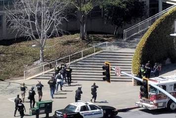 Law enforcement officials react following a possible shooting at the headquarters of YouTube in San Bruno, California