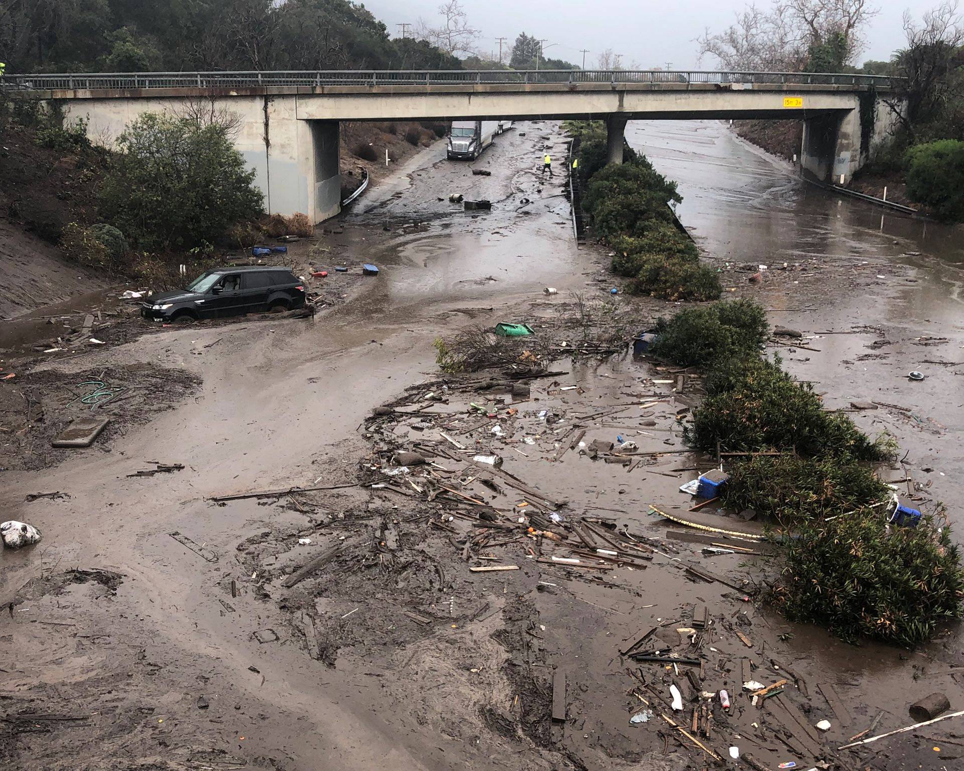 Abadoned cars stuck in flooded water on the freeway after a mudslide in Montecito
