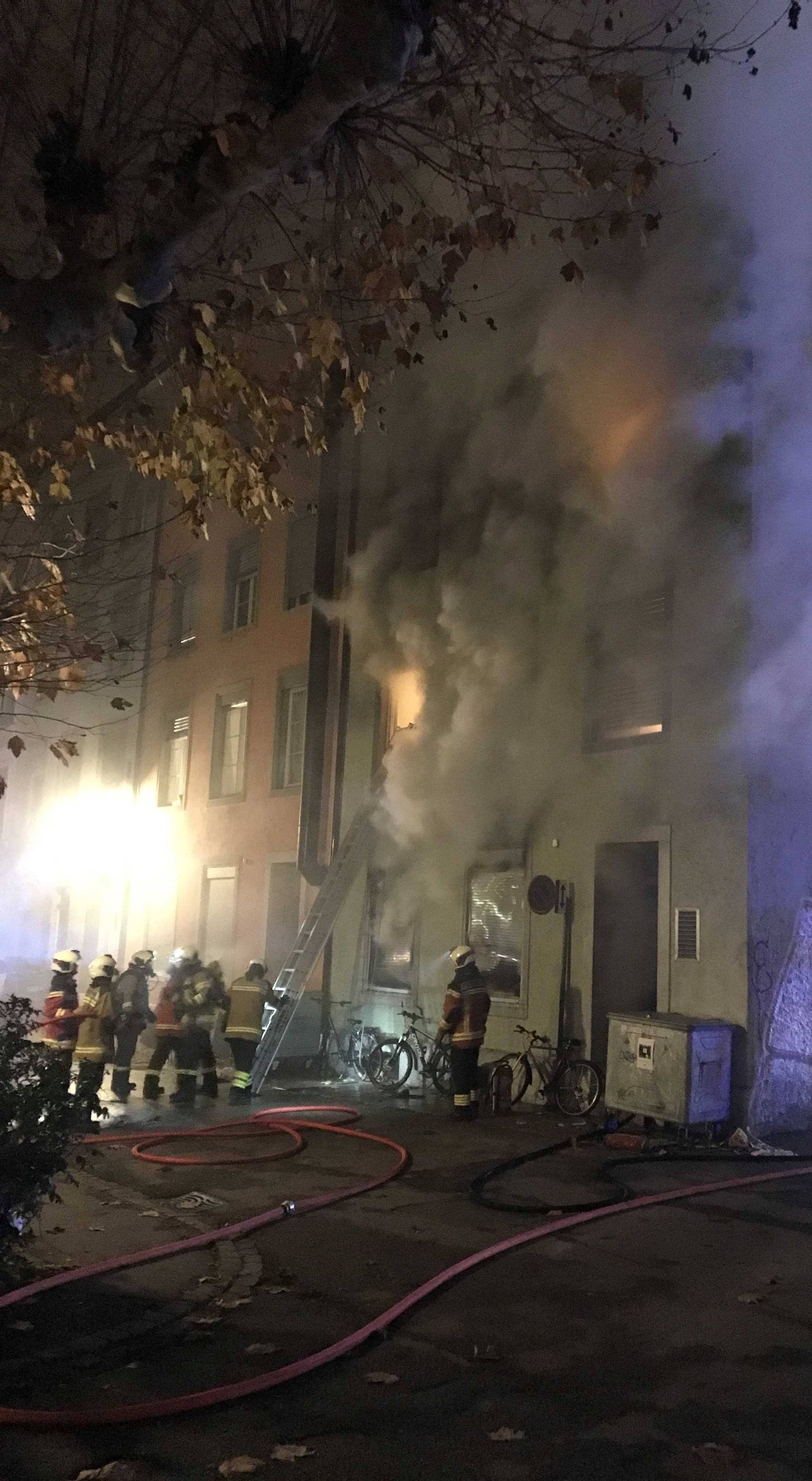 Firefighters are seen in front of a house where six people were killed in an apartment fire early on Monday morning, police said, in Solothurn