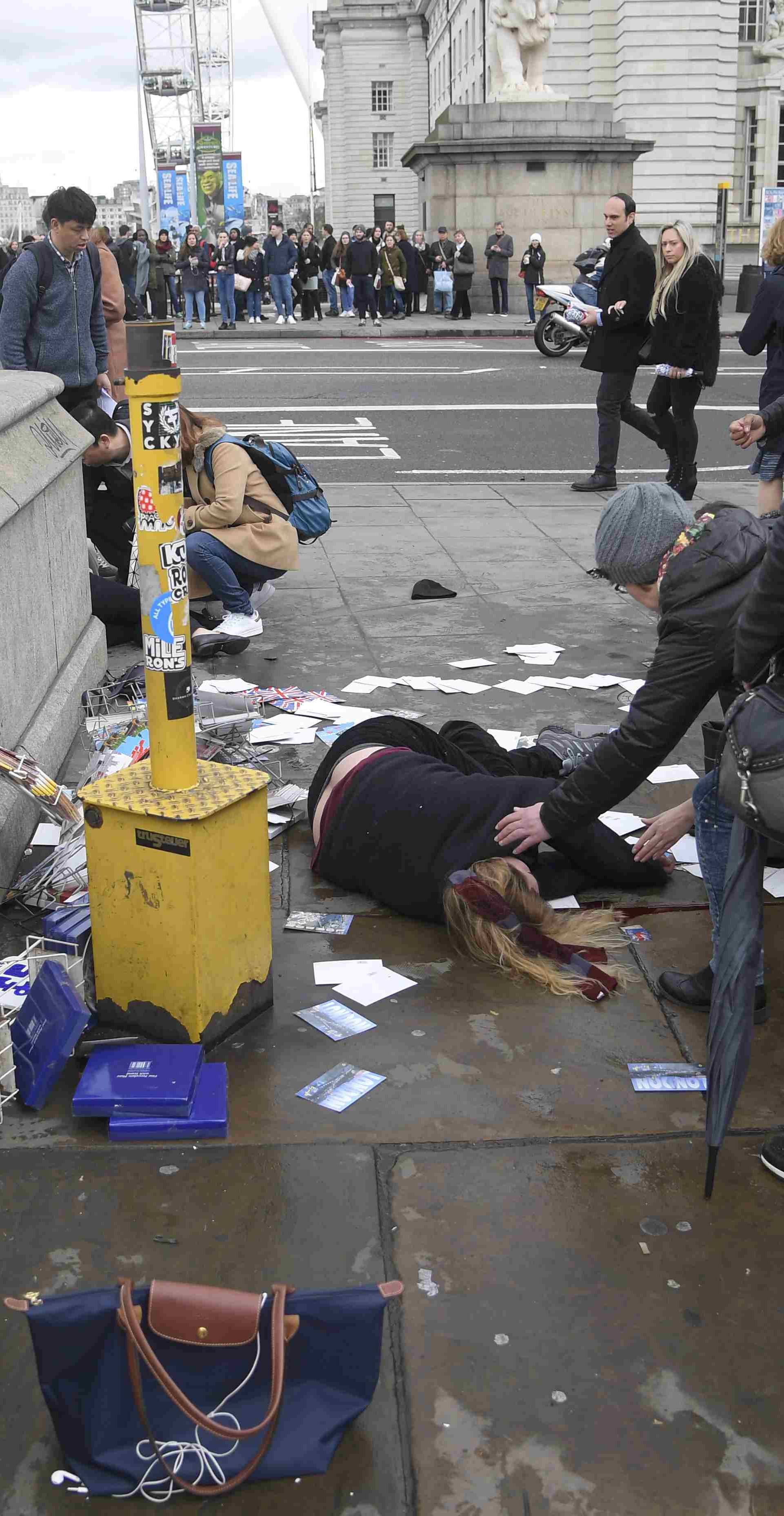 A woman lies injured after a shottingt incident on Westminster Bridge in London