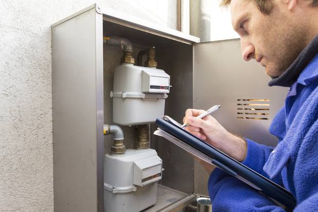 plumber at work making the consumption metering