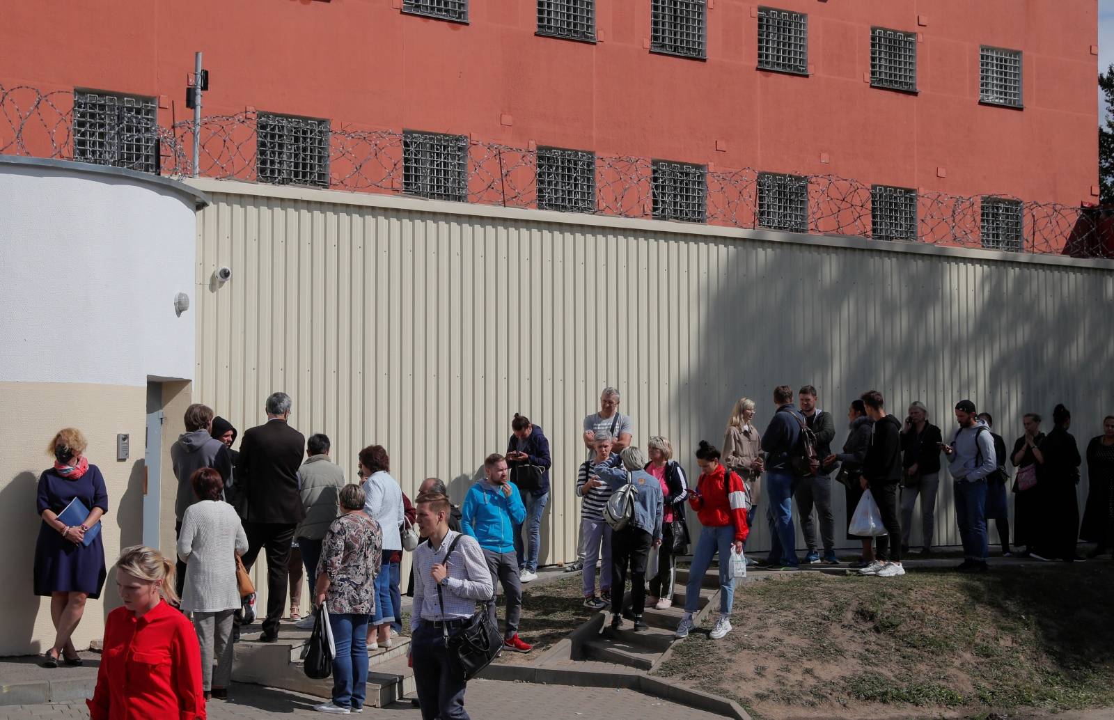 People gather outside a detention centre following recent protests against presidential election results in Minsk