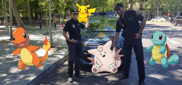 Handout photo of Spanish police posing with "Pokemon Go"  figures 