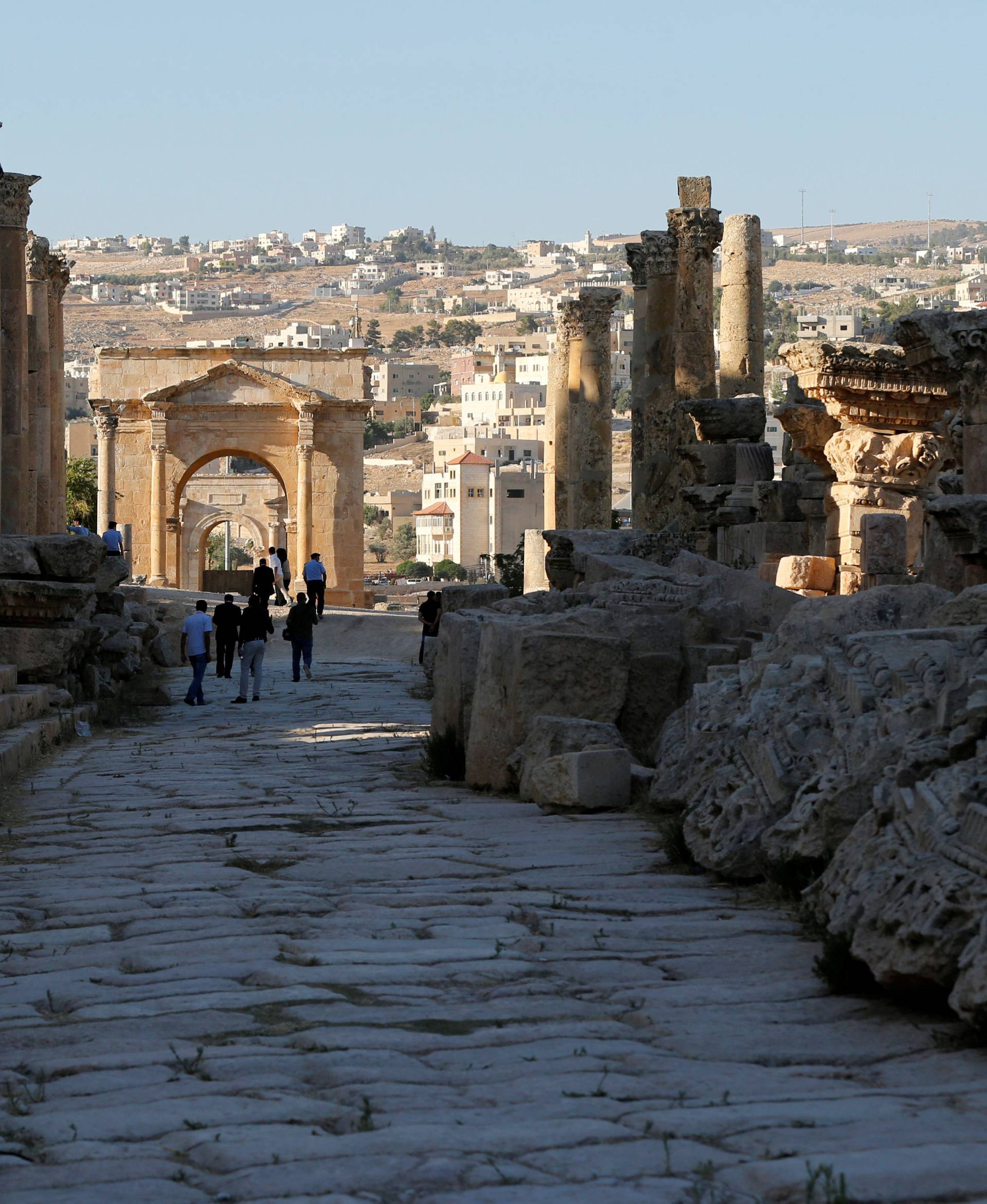 FILE PHOTO: People walk along the ruins of the ancient Roman city of Jerash during the Jerash Festival of Culture and Arts in the ancient city of Jerash