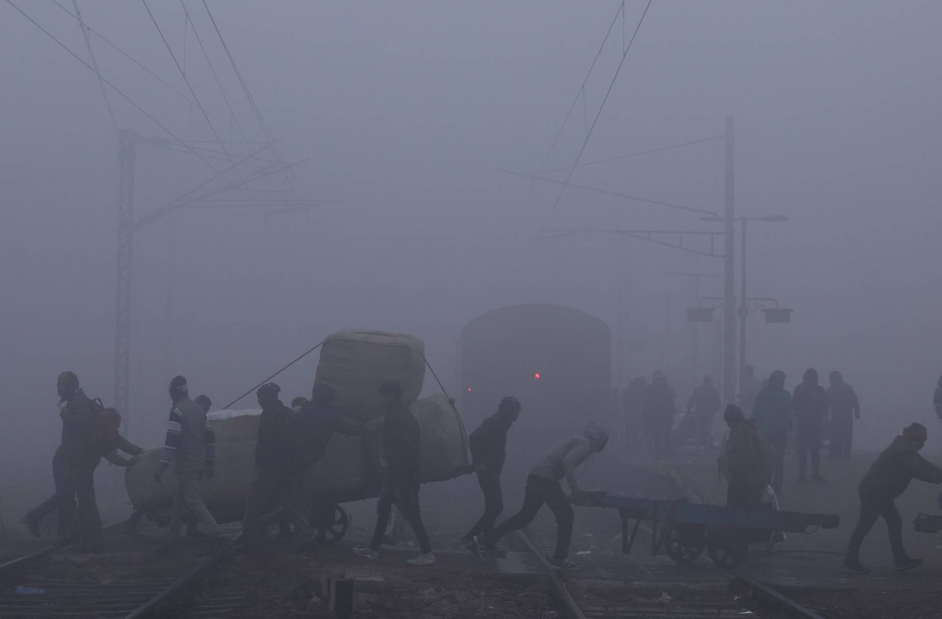 Railway tracks amidst heavy fog on a cold winter morning in New Delhi