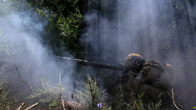 Ukrainian service members fire an anti-tank grenade launcher at a front line near the city of Bakhmut