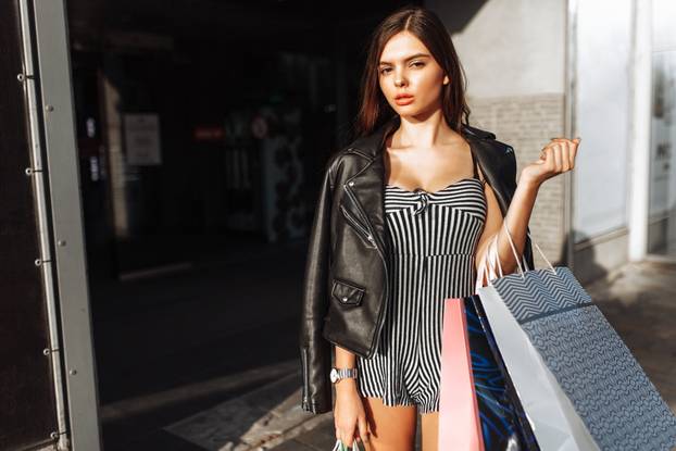 Beautiful Stylish Girl with Bags Walking Down the Street, After Shopping, Holding Bags, Outdoors