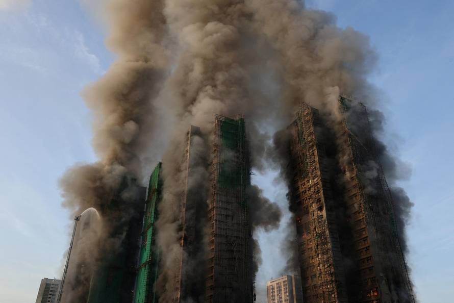 Flames engulf bamboo scaffolding across multiple buildings at Wang Fuk Court housing estate, in Tai Po