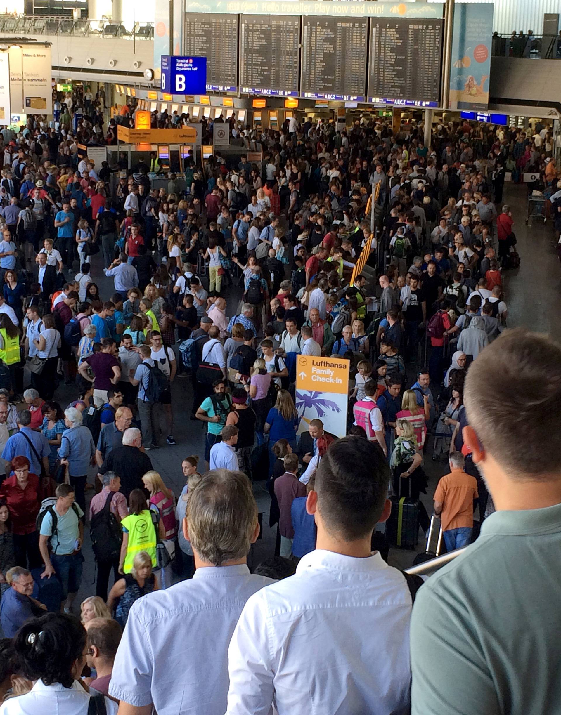 People gather at Frankfurt airport terminal after Terminal 1 departure hall was evacuated in Frankfurt,