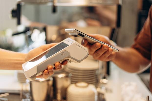 Customer,Is,Holding,His,Smartphone,Over,A,Payment,Terminal,,Making