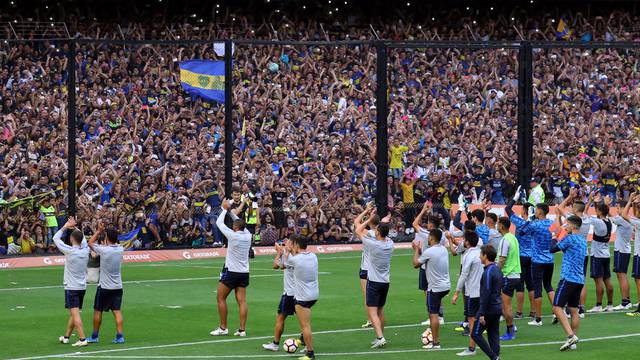 Boca Juniors' players acknowledge supporters during a training session ahead of their second leg Copa Libertadores final match against River Plate in Buenos Aires