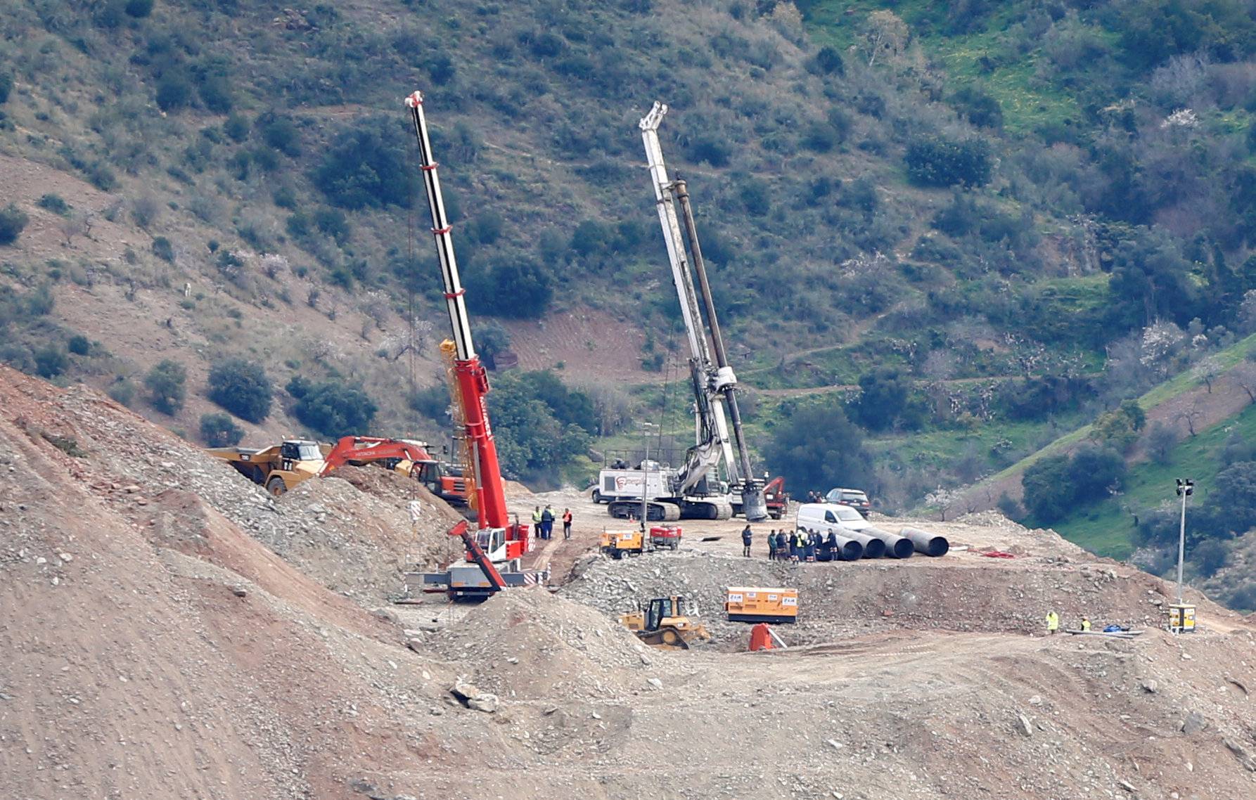 Miner rescue team stands next to steel tubes after failing the placement of them into the drilled well at the area where Julen fell into a deep well in Totalan