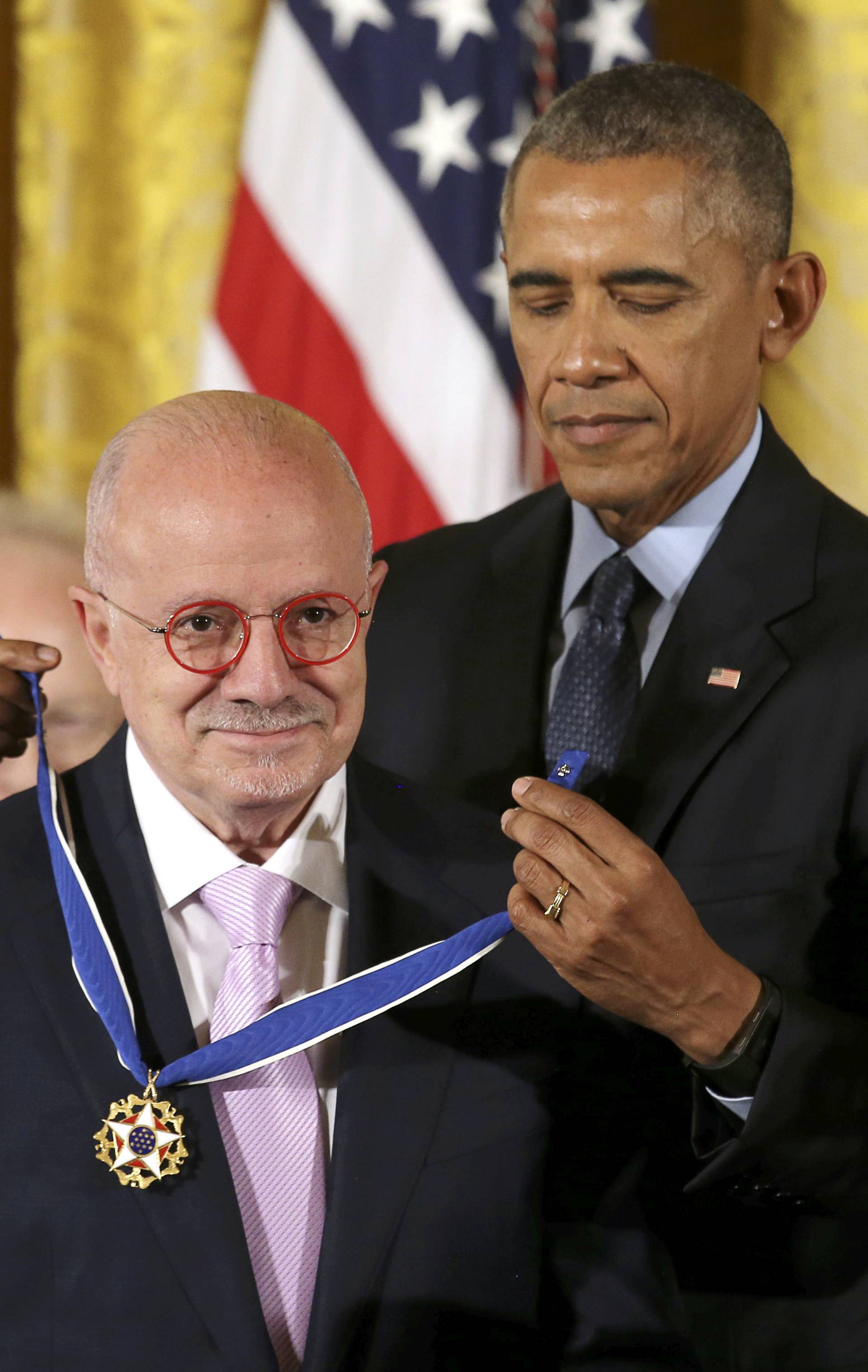 President Obama puts Presidential Medal of Freedom on Miami Dade College president Padron at White House in Washington