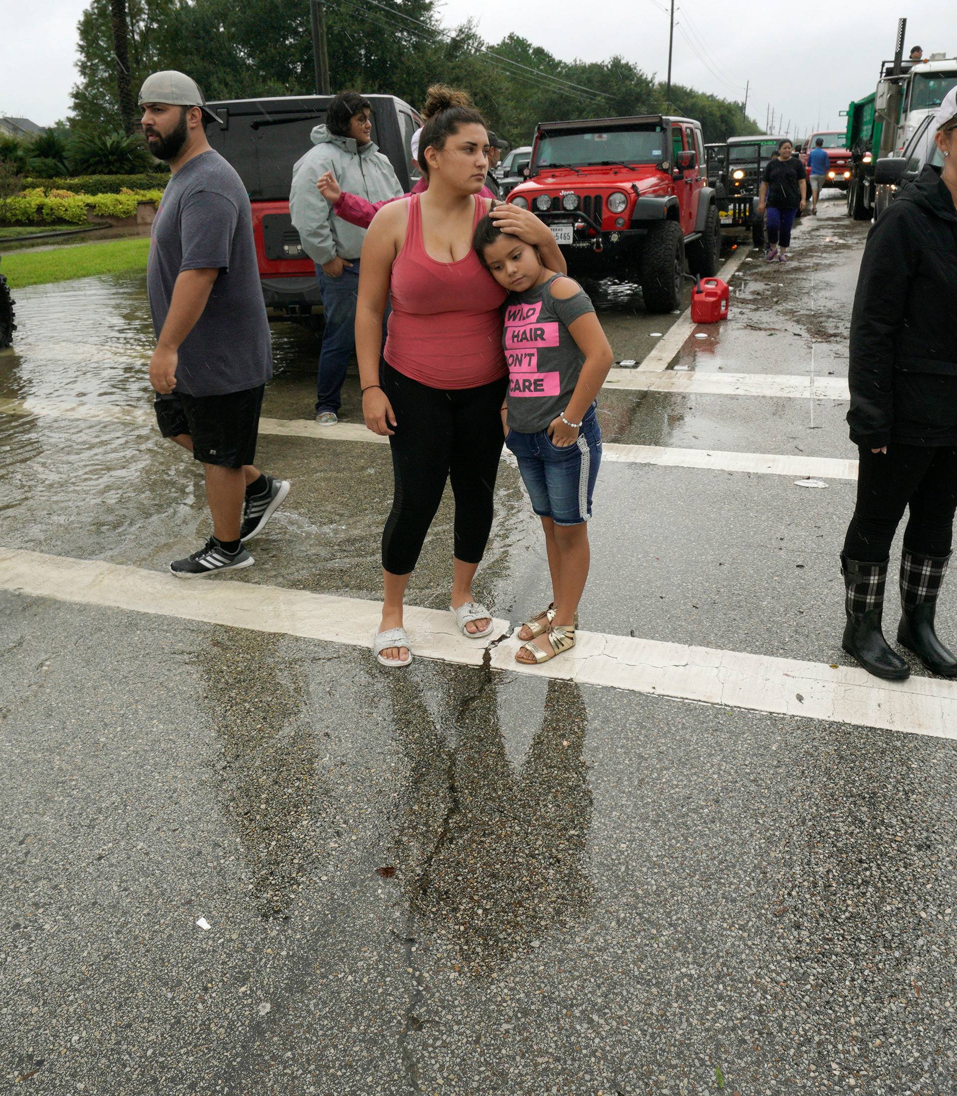 Crystal Lainev and her cousin Crystal Garcia hug near the Hurricane Harvey floodwaters in Houston