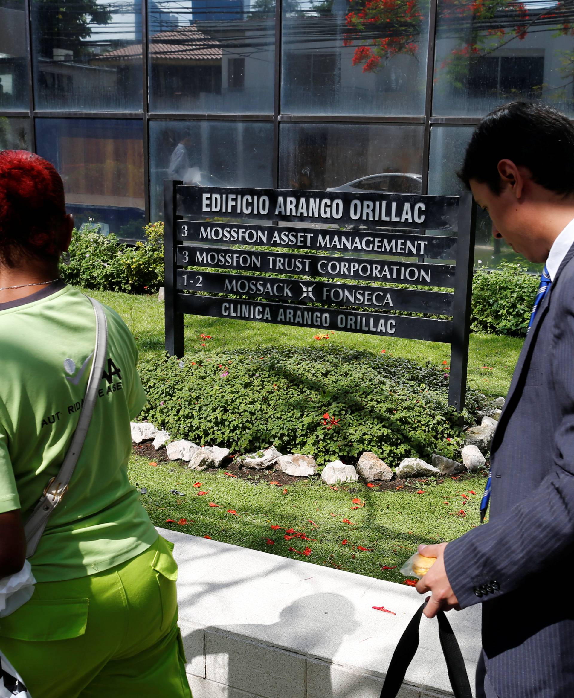 A man walk pass a company list showing the Mossack Fonseca law firm at the Arango Orillac Building in Panama City