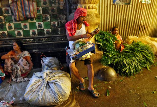 A vendor prepares paan at a market in Kolkata