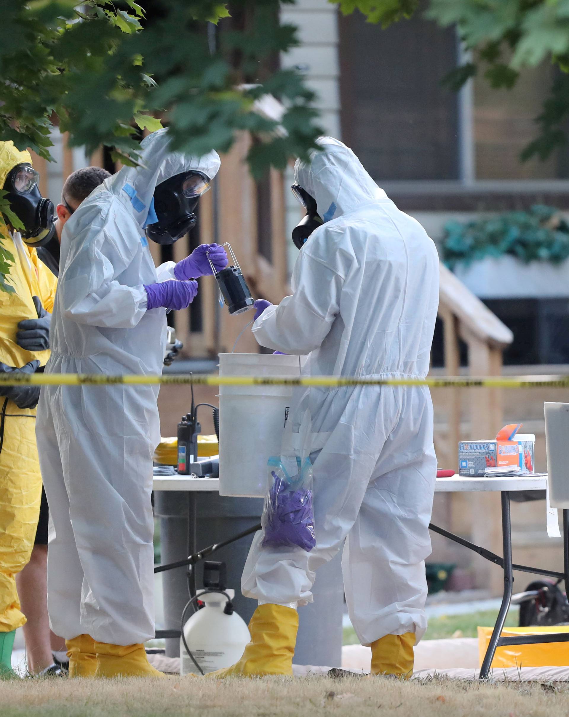 FILE PHOTO: FBI and law enforcement officers in hazmat suites prepare to enter a house which FBI says was investigating "potentially hazardous chemicals" in Logan