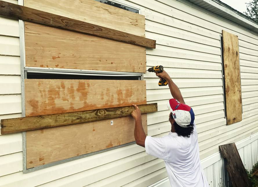 Filomeno Romero, 52, reinforces his mobile home ahead of the approach of Hurricane Irma in Apopka