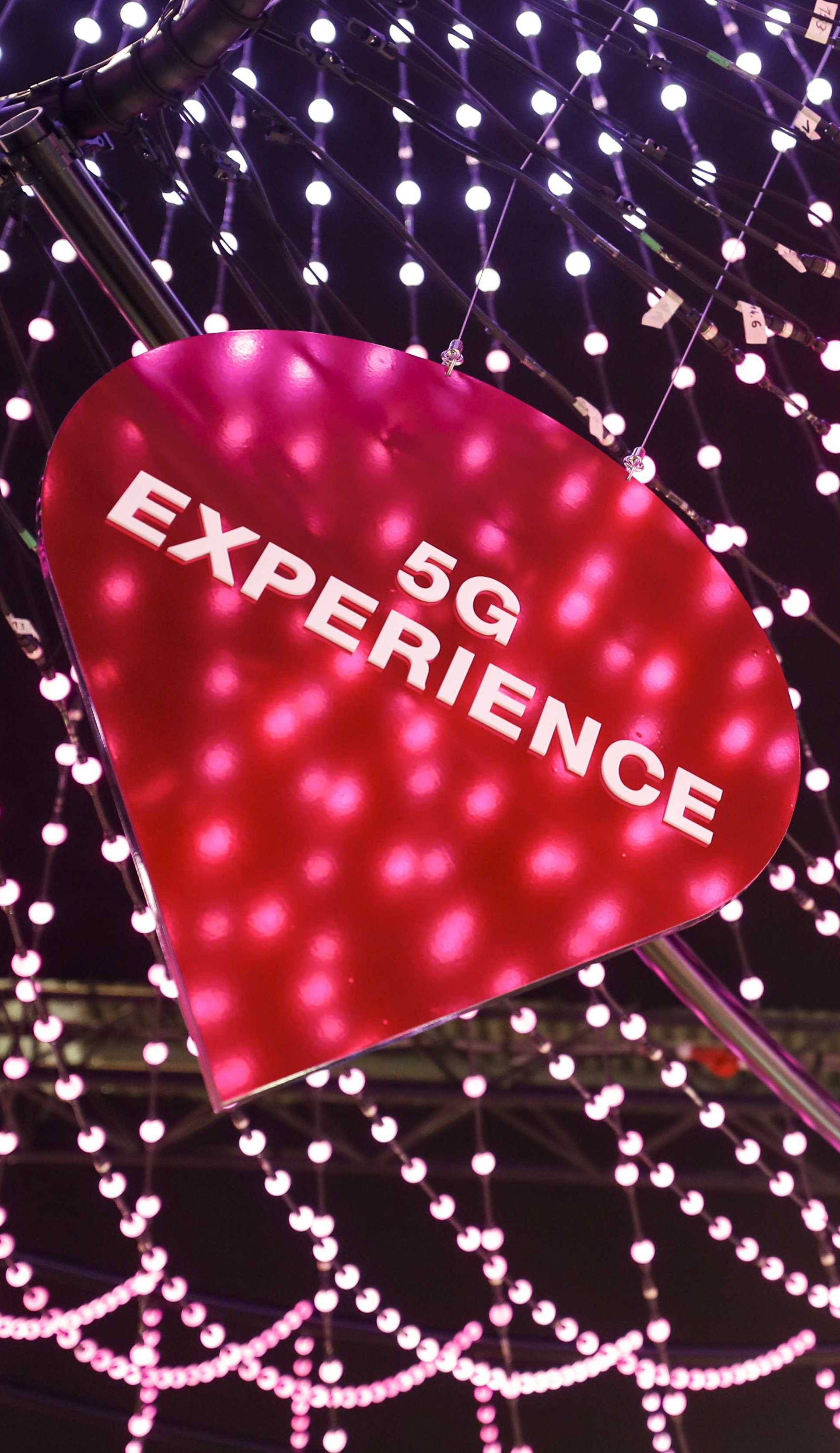 A 5G banner hanging at the Deutsche Telekom booth is seen at the Mobile World Congress in Barcelona