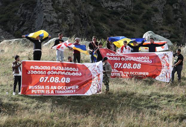 Georgian opposition activists protest against the arrival of Russian citizens near Zemo Larsi border crossing