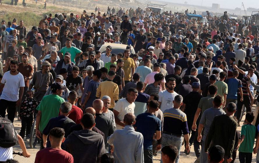 Palestinians seeking aid gather near an aid distribution site run by the U.S.-backed Gaza Humanitarian Foundation, in Rafah