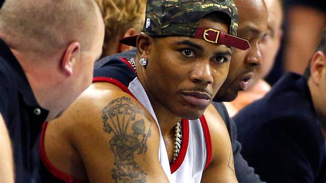 FILE PHOTO: Recording artist Nelly watches the game between the New York Knicks and the Charlotte Bobcats during an NBA basketball game in Charlotte