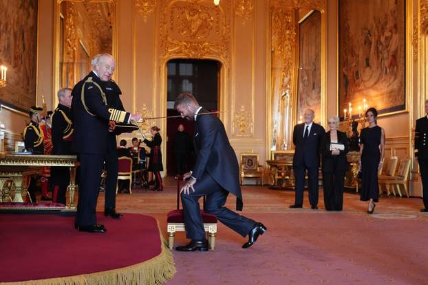 Sir David Beckham is made a Knight Bachelor by King Charles III during an Investiture ceremony at Windsor Castle, Berkshire. The honour recognises services to sport and to charity. Picture date: Tuesday November 4, 2025.