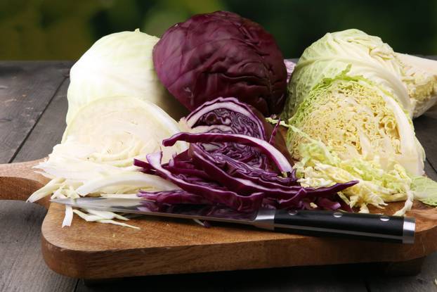 Shredded cabbage, white cabbage, red cabbage and savoy on cutting board