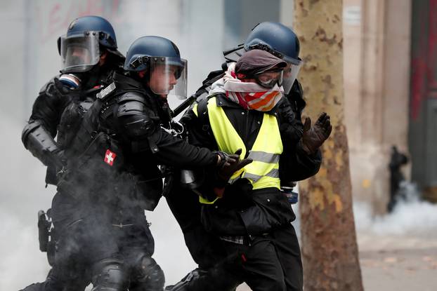 French gendarmes apprehend a protester during clashes at a demonstration by the "yellow vests" movement in Paris