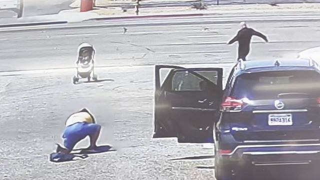 Baby in a stroller rolls towards traffic as woman trips and falls in heart-stopping video