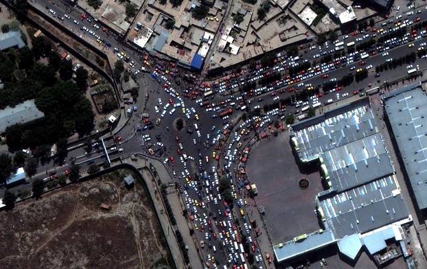 An overview of crowds and trafic at an entrance to Kabul